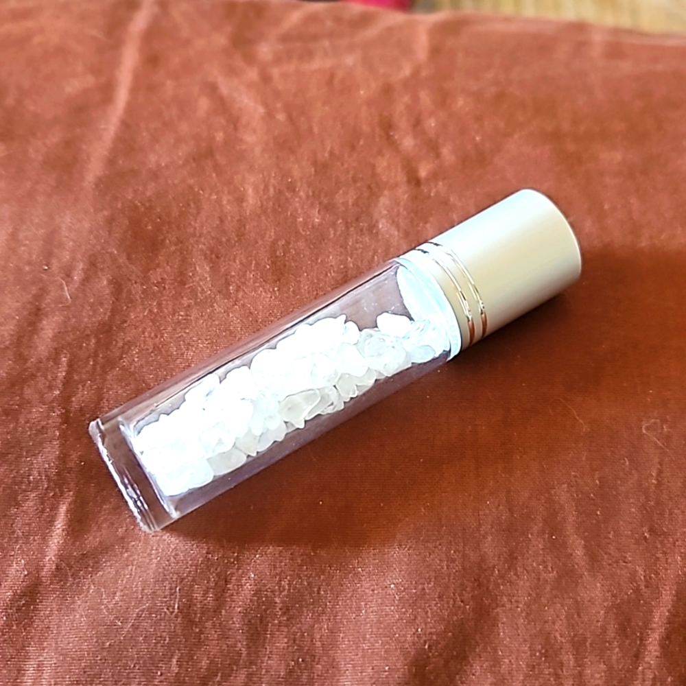 Empty glass roll on bottle with Clear Quartz chips inside